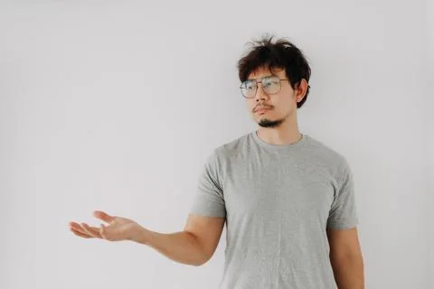 Bored face man pointing on empty space for advertisement isolated on white. Foto stock