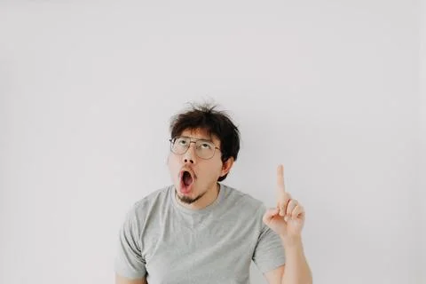 Bored face man presenting advertisement with shocked mouth isolated on white. Stock Photos
