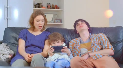 Bored family sitting on the sofa Stock Footage