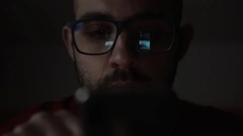 Bored Guy In The Dark While Scrolling Feeds Through His Phone. Night insomnia Stock Footage 152040026