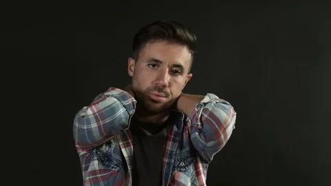 Bored guy having an idea on black background. Curiosity Stock Footage 80303535