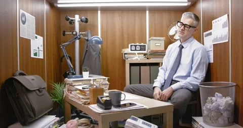Bored inefficient employee wasting time in his small office Stock Footage 309020327
