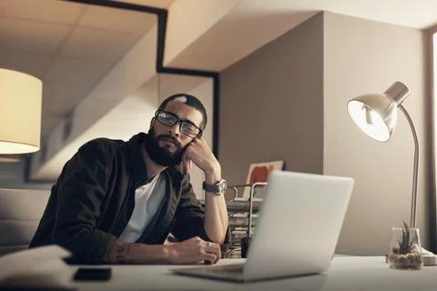 Bored, laptop and thinking with programmer man in office at night for coding or Stock Photos