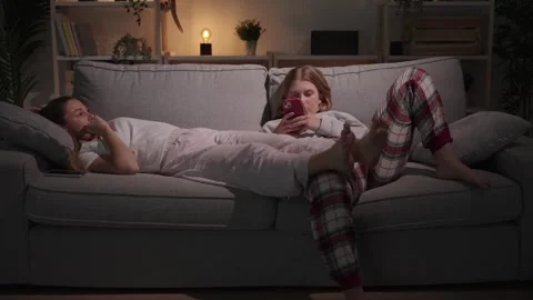 Bored lesbian couple lying on sofa Stock Footage 241227254