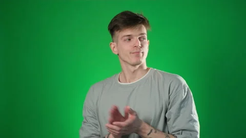 Bored man clapping hands on green background Stock Footage 209132341