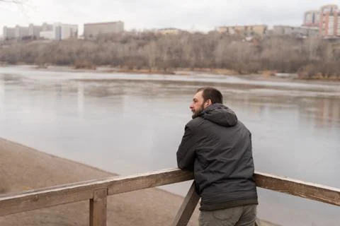 Bored man looking at the river Stock-Fotos