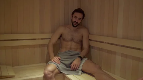 Bored man resting and sweating alone in the spa sauna Stock Footage 127649059