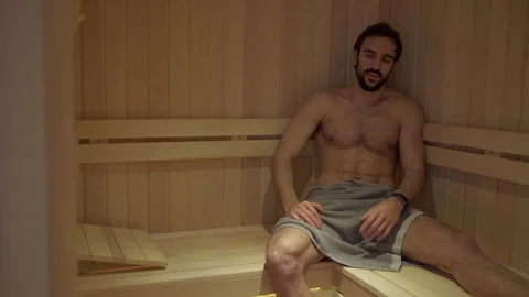 Bored man thinking and sweating alone in the spa sauna Stock Footage 127649067