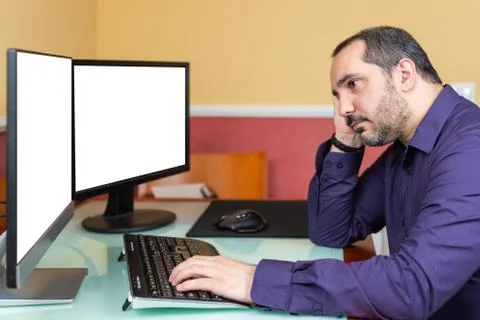 Bored man using computer. Telework concept Photos