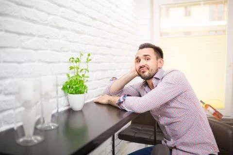 Bored man waiting for dinner in kitchen Stock Photos