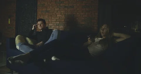 Bored middled aged couple watching tv at home. Family, relationship, marriage Stock Footage 128995367