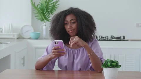 Bored multi-ethnic woman using mobile phone, scrolling news feed with neutral Stock Footage 219950672