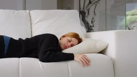 Bored or Exhausted Young Sleepy Woman Falls Asleep On Sofa. Stock Footage 247206853