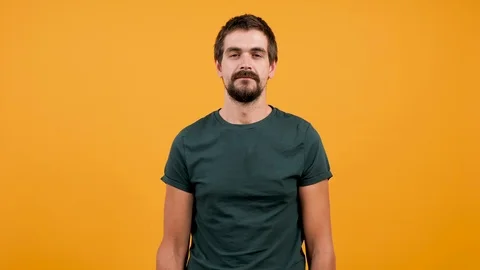 Bored puzzled man slaps himself a couple of times with both hands Stock Footage 92988309