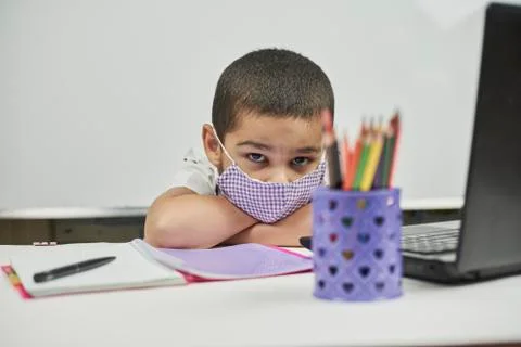 Bored schoolboy from online classes. Back to school. Tired of homework Stock Photos