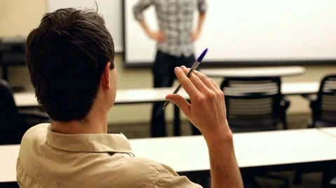 Bored student flicking pen while someone talks Stock Footage 10720661
