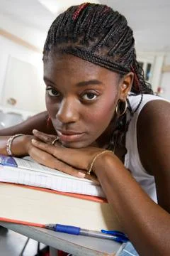 Bored Student Resting On Stack Of Books Foto stock