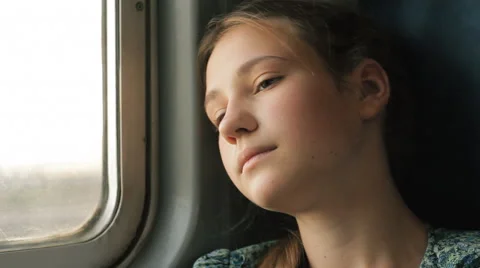 Bored Teen Girl Looking Out Window While Traveling By Train HD Stock Footage