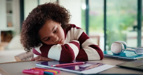 Bored, tired and kid with homework in house with elearning, education or online Stockbeeldmateriaal 335795475