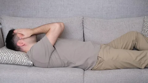 Bored upset man lying on the sofa Video stock 265277358