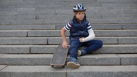 Bored white boy with broken arm Stock Footage 83270768