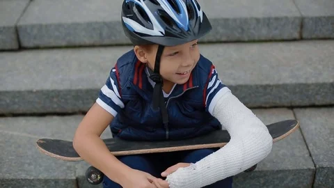 Bored white boy with broken arm Stock Footage 83997078