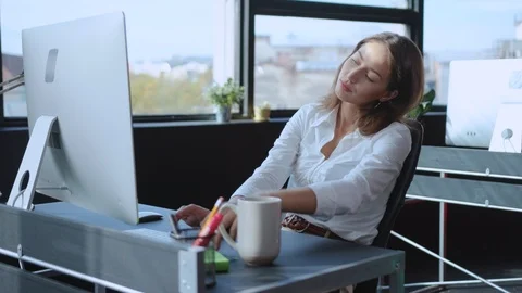 Bored young female employee wasting time at work suffering lack of interest or Stock Footage