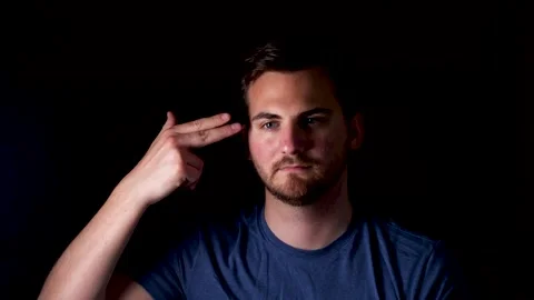 Bored young man gesturing headshot. Touching temple with fingers forming Stock Footage 131086562