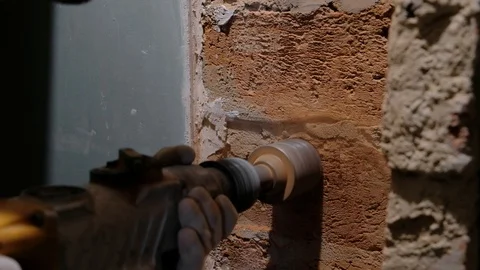 Boring out a hole for socket box in a brick wall, construction work Video stock 109151209