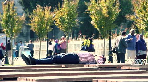 Boring vacation man while tourists shoot photo in background Stock-Footage 57671156