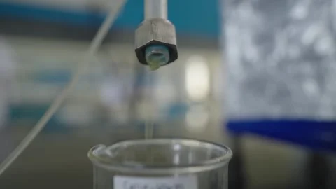 Borosilicate Glass Beaker getting filled closeup Stock Footage 322150876