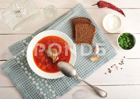 Borsch with beef, sour cream and parsley with vodka decanter Stock Photos