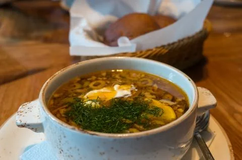 Borscht or borsht soup in a rustic bowl with sour cream and dill Stock Photos