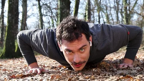 Bosco 19The runner is doing push-ups in the woods. Stock Footage 228947359