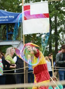 Bosco the Jester points at a floating bubble Stock Photos