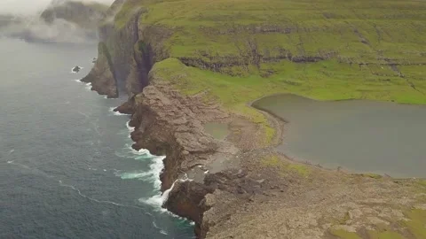 Bøsdalafossur waterfall flowing from Sørvágsvatn on Vágar, Faroe Islands. Stock Footage