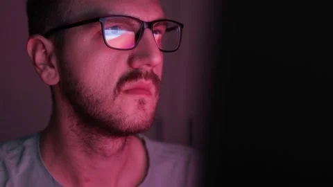 Bosnian programmer wearing glasses watching something on the computer screen Stock Footage 166750681