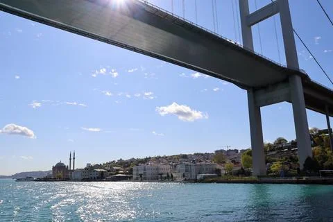 Bosphorus Bridge from below with sunlight and water reflection, Istanbul Stock Photos