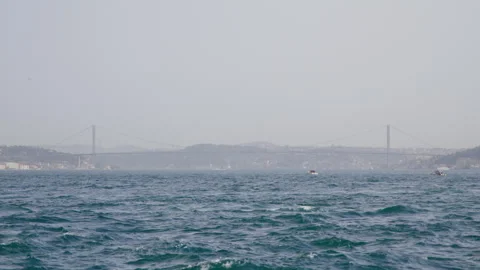 The Bosphorus Strait in Istanbul, featuring a connecting bridge, city skyline 動画素材 283333119