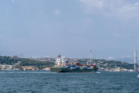 Bosphorus Strait showcases a cargo ship navigating between the European and Stock Photos