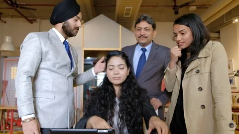 Boss busy on her phone while the team talks behind her back Stock Footage 101890789
