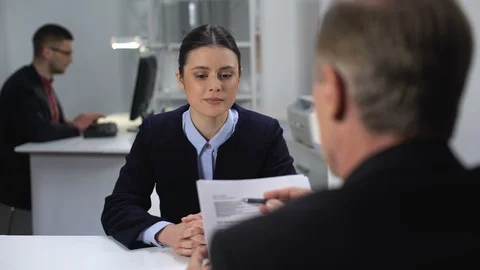 Boss checking female employee work results, probationary period at workplace Stock Footage 112096515
