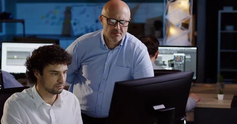 Boss of the company checking the work of his office worker about business Stock Footage 82474068