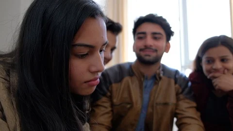 Boss in focus concentrating on computer while her team in the back make fun and  Stock Footage 101188487