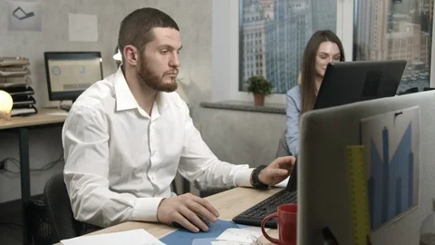 Boss giving task to a young man in an office Stock Footage 125456779