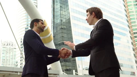  Boss greeting his office worker by handshake and give sump up, compliments  Stock Footage