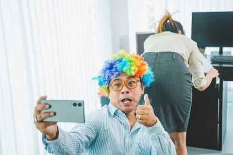 Boss or supervisor is secretly using a mobile phone to film the buttocks of.. Foto stock