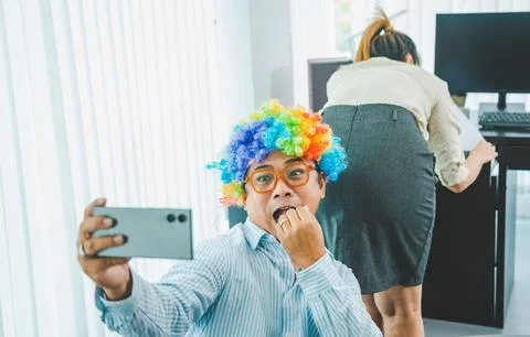 Boss or supervisor is secretly using a mobile phone to film the buttocks of.. Foto stock