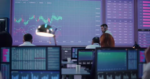 Boss speaking with stock traders in office Stock Footage 148230134