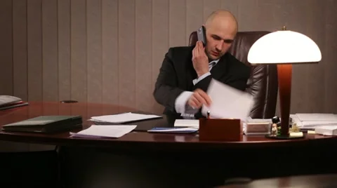 Boss talking on the phone in office Stock Footage 10955610
